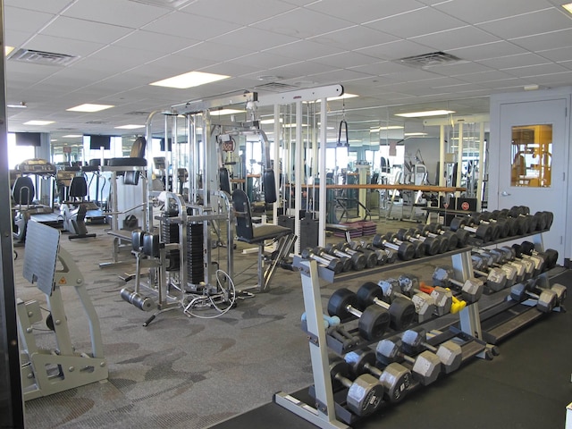 exercise room with visible vents and a drop ceiling