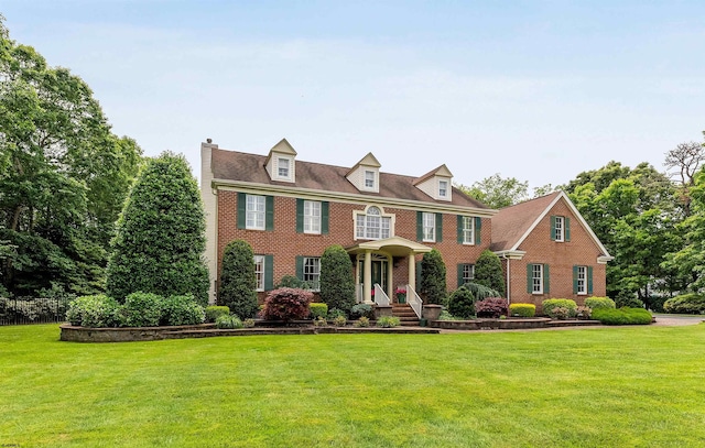 colonial-style house with a front yard