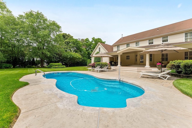 view of pool featuring a yard and a patio