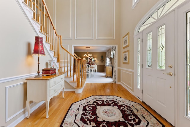 entryway with a chandelier, light hardwood / wood-style flooring, and a healthy amount of sunlight