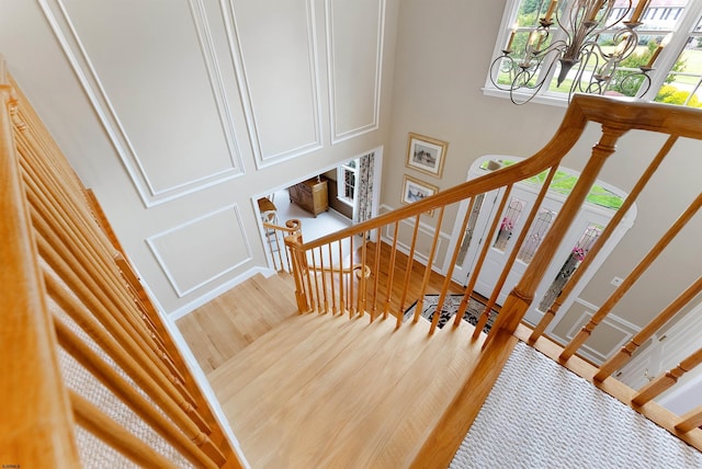 staircase with hardwood / wood-style flooring