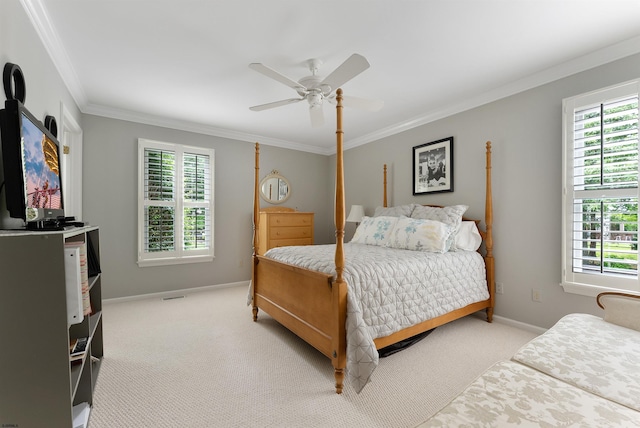 carpeted bedroom featuring ceiling fan and crown molding