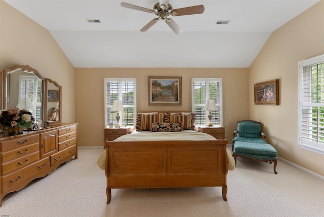 bedroom with ceiling fan, lofted ceiling, light carpet, and multiple windows