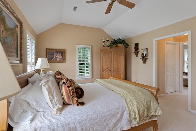 carpeted bedroom with vaulted ceiling and ceiling fan