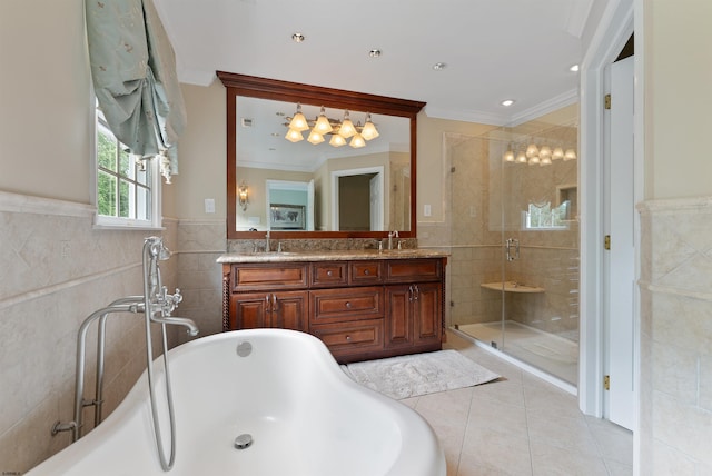 bathroom featuring plus walk in shower, tile patterned floors, crown molding, vanity, and tile walls