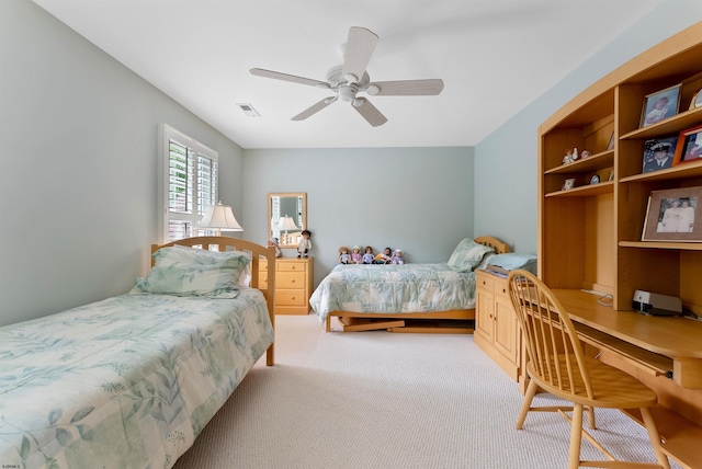 bedroom with ceiling fan and light carpet