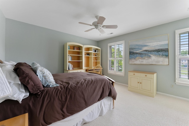 bedroom featuring ceiling fan and light carpet