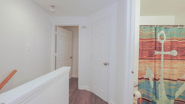 hallway with dark hardwood / wood-style floors