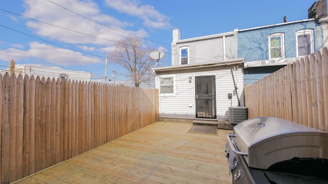 wooden deck featuring area for grilling and central AC unit