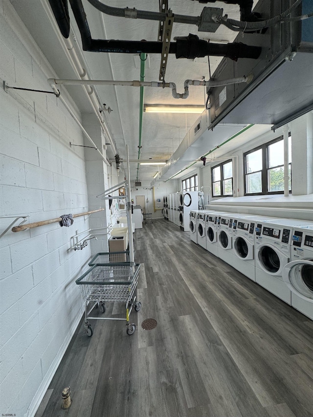 washroom with washer and clothes dryer and dark wood-type flooring