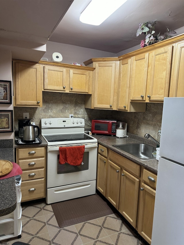 kitchen with backsplash, sink, and white appliances