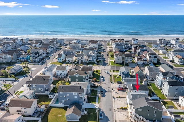 bird's eye view featuring a water view and a beach view