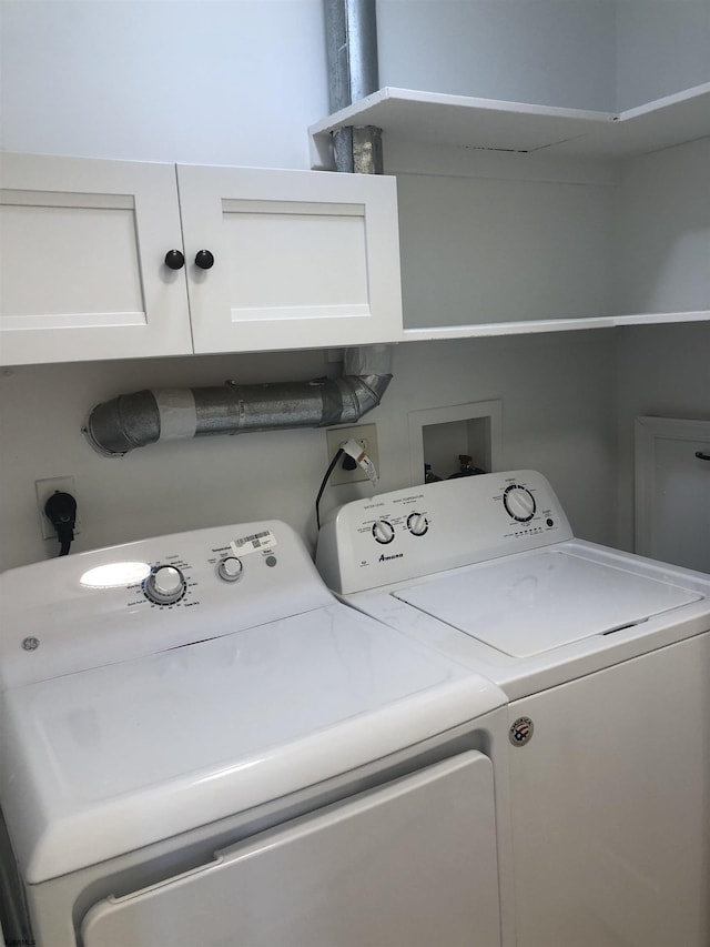 washroom with washer and clothes dryer and cabinets