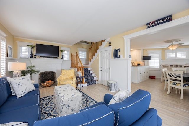 living room featuring ceiling fan and light hardwood / wood-style floors