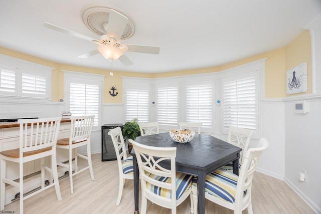 dining area with ceiling fan and light hardwood / wood-style floors