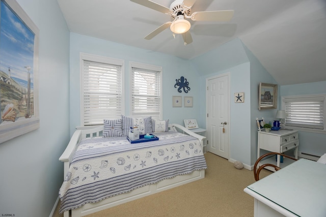 carpeted bedroom with vaulted ceiling, ceiling fan, and a baseboard radiator