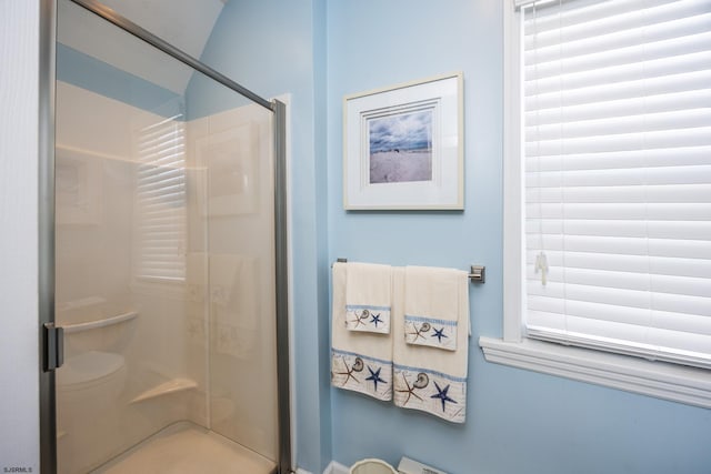 bathroom featuring a wealth of natural light and a shower with door