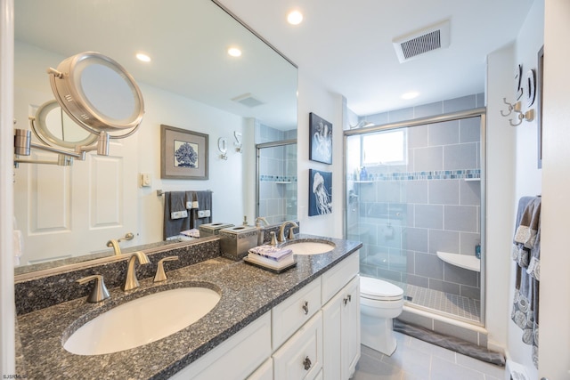 bathroom with toilet, walk in shower, vanity, and tile patterned flooring