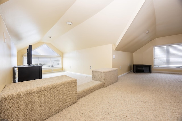 bonus room with carpet flooring and lofted ceiling