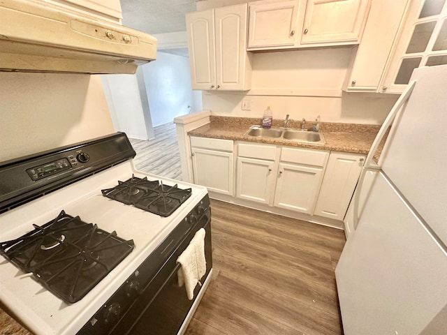 kitchen featuring white cabinetry, hardwood / wood-style floors, sink, and white appliances