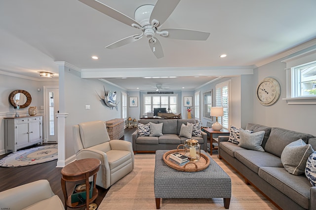 living room with ceiling fan, light wood-type flooring, and ornamental molding