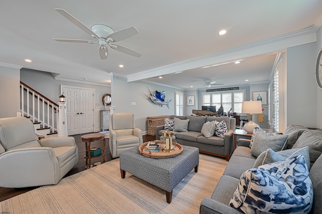 living room featuring light wood-type flooring, ceiling fan, and ornamental molding