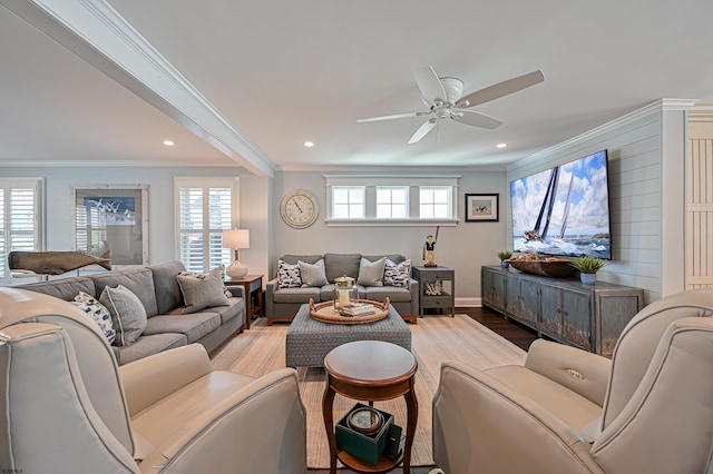 living room featuring light hardwood / wood-style floors, ceiling fan, and ornamental molding