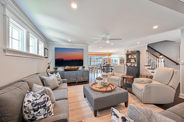 living room with ceiling fan, crown molding, and light hardwood / wood-style flooring