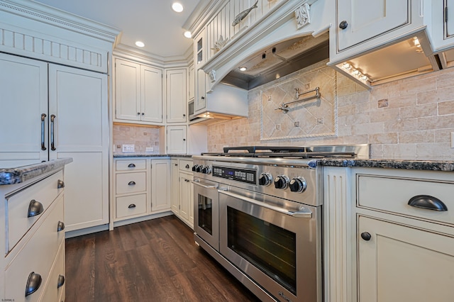 kitchen featuring white cabinets, custom range hood, and range with two ovens