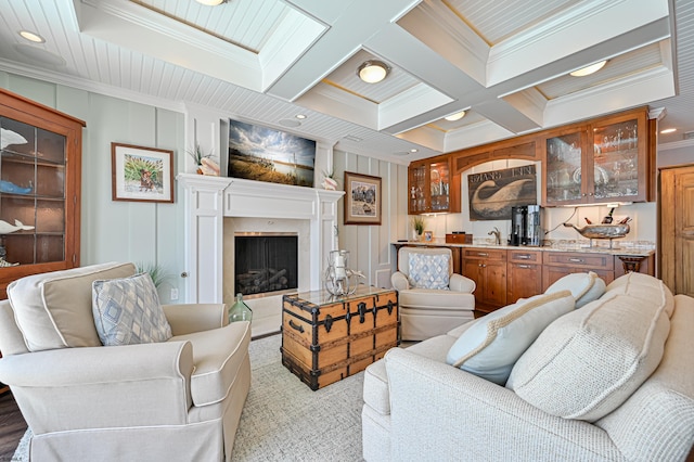 living room featuring beam ceiling, crown molding, and coffered ceiling