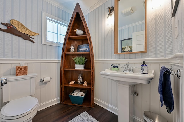 bathroom featuring hardwood / wood-style floors, toilet, and ornamental molding