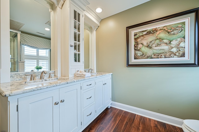 bathroom with hardwood / wood-style floors, vanity, and toilet