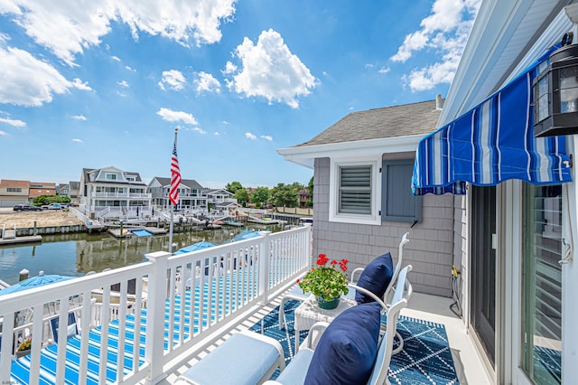 balcony featuring a water view