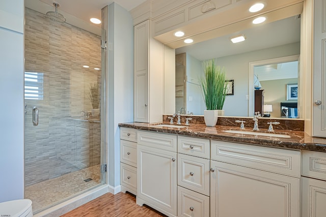 bathroom with vanity and a shower with shower door