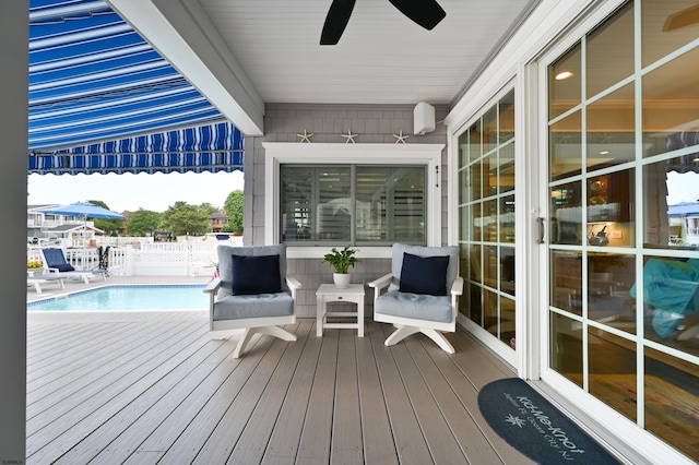 wooden terrace with a fenced in pool