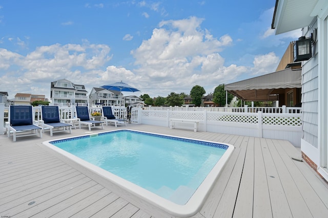 view of swimming pool featuring a wooden deck