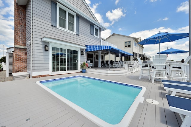 view of swimming pool with a deck