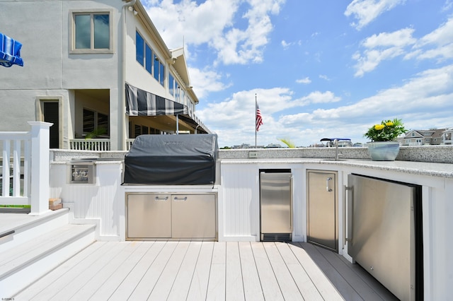 deck featuring grilling area and exterior kitchen