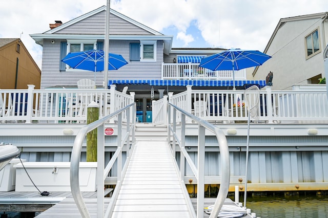 back of house featuring a deck with water view