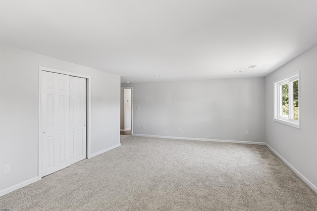 unfurnished bedroom with carpet and a closet