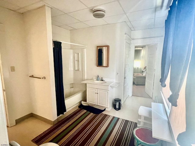 bathroom with a paneled ceiling, shower / bath combo, and vanity