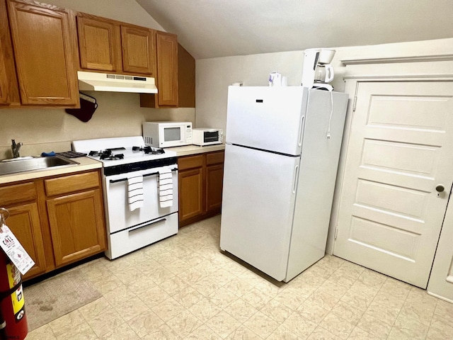 kitchen featuring white appliances, vaulted ceiling, and sink