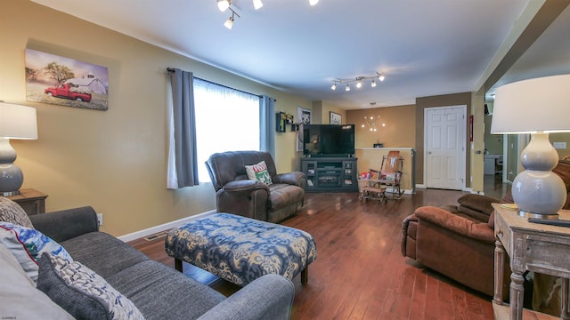 living room featuring track lighting and dark hardwood / wood-style flooring