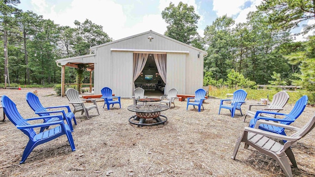 view of patio featuring an outdoor structure and an outdoor fire pit