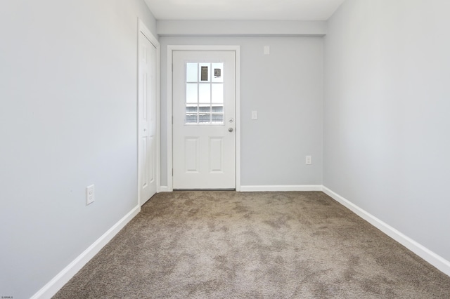 doorway to outside featuring carpet floors