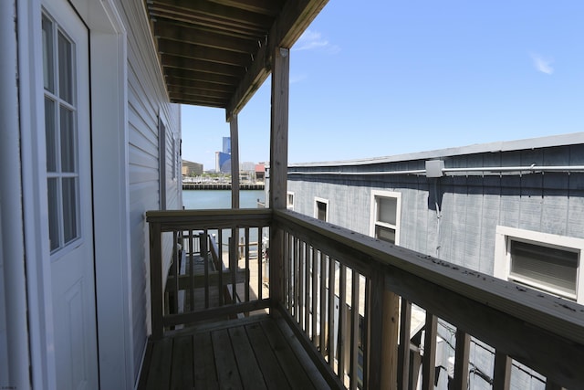 wooden terrace featuring a water view