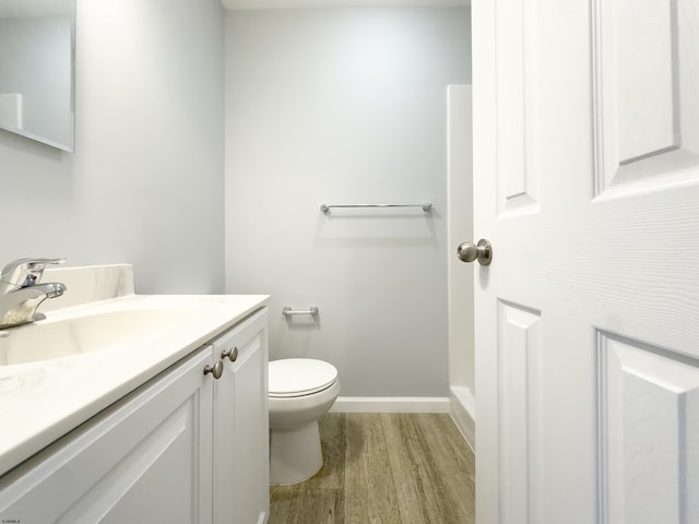 bathroom with vanity, hardwood / wood-style flooring, and toilet