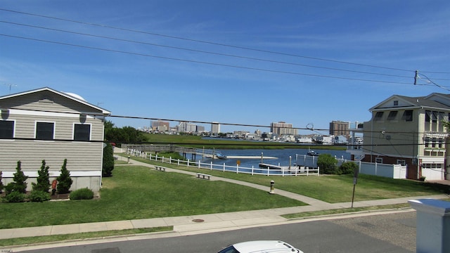 exterior space featuring a water view and a front lawn