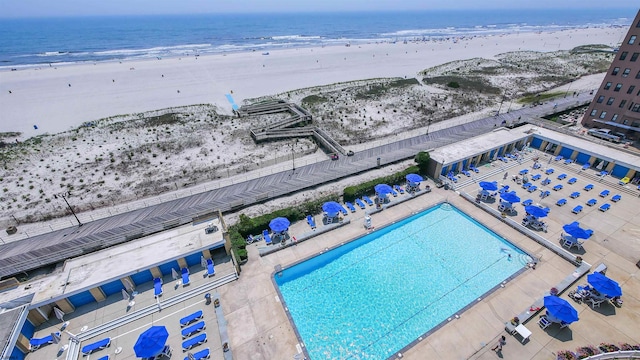 drone / aerial view with a water view and a view of the beach