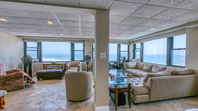 living room featuring a water view and light tile patterned floors